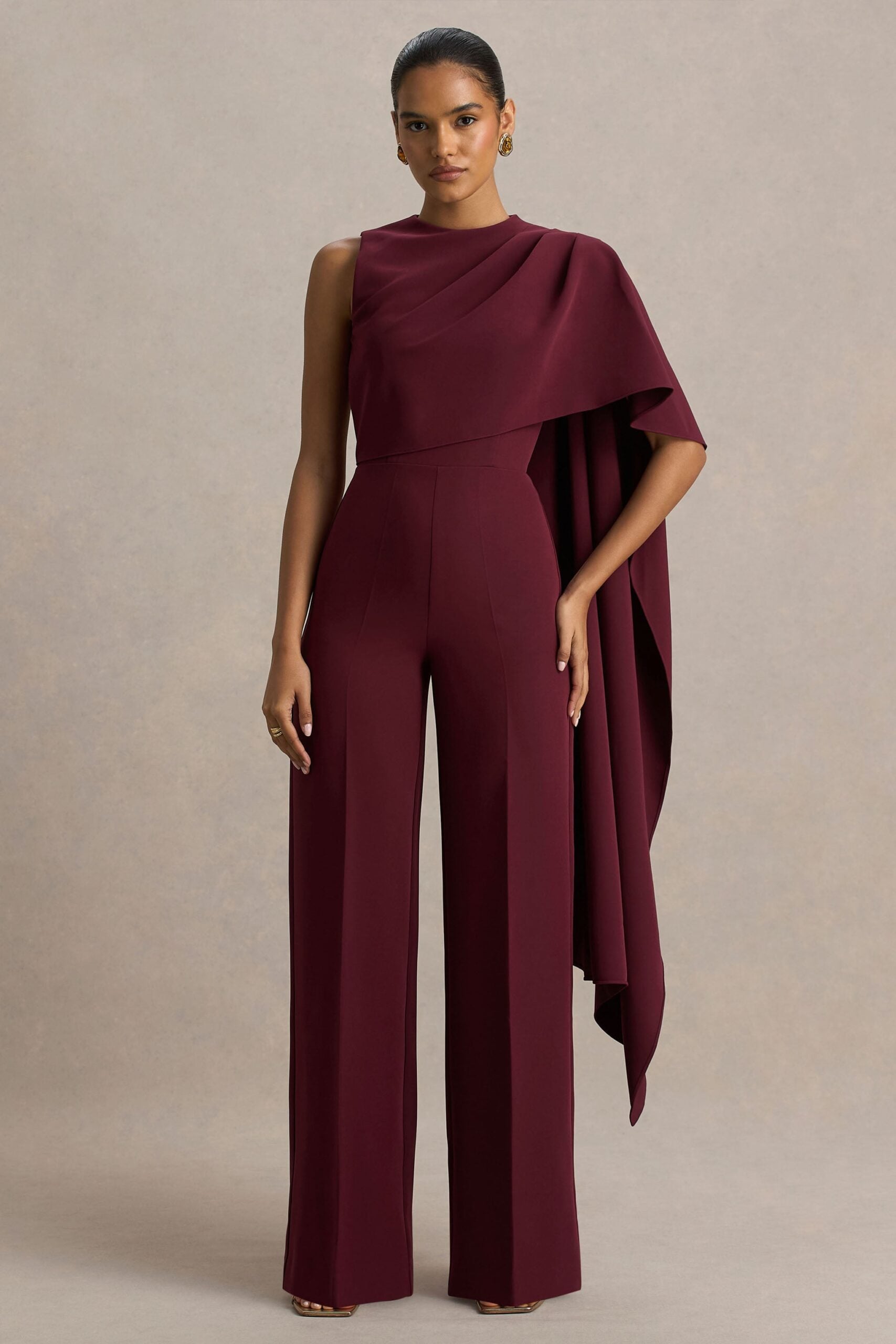 Club L London Sorenia | Burgundy High-Neck Jumpsuit With One-Cape Sleeve - Image 1