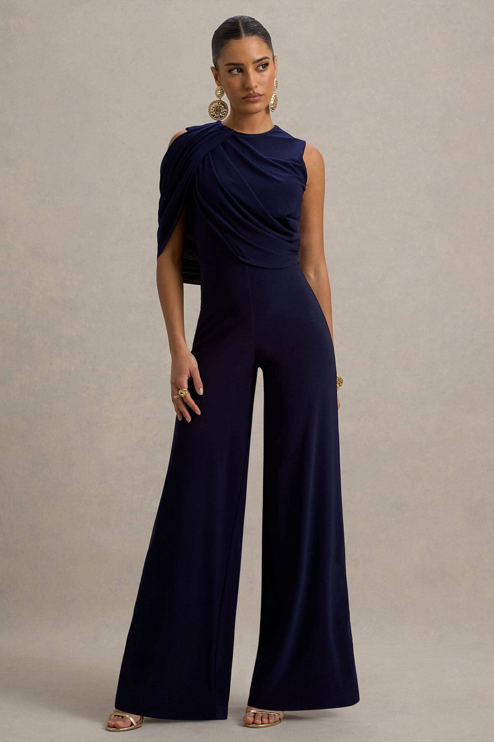 Club L London Opulence | Navy Jumpsuit With Cape Sleeve and Draped Details - Image 1